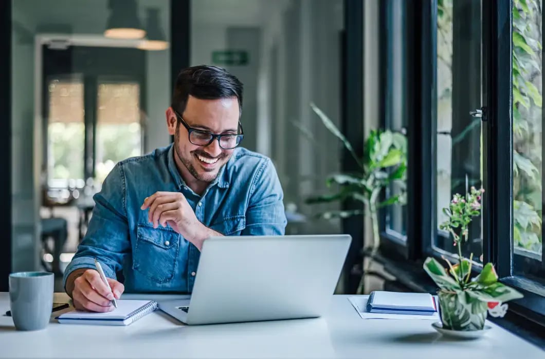 Person working on a laptop at a desk