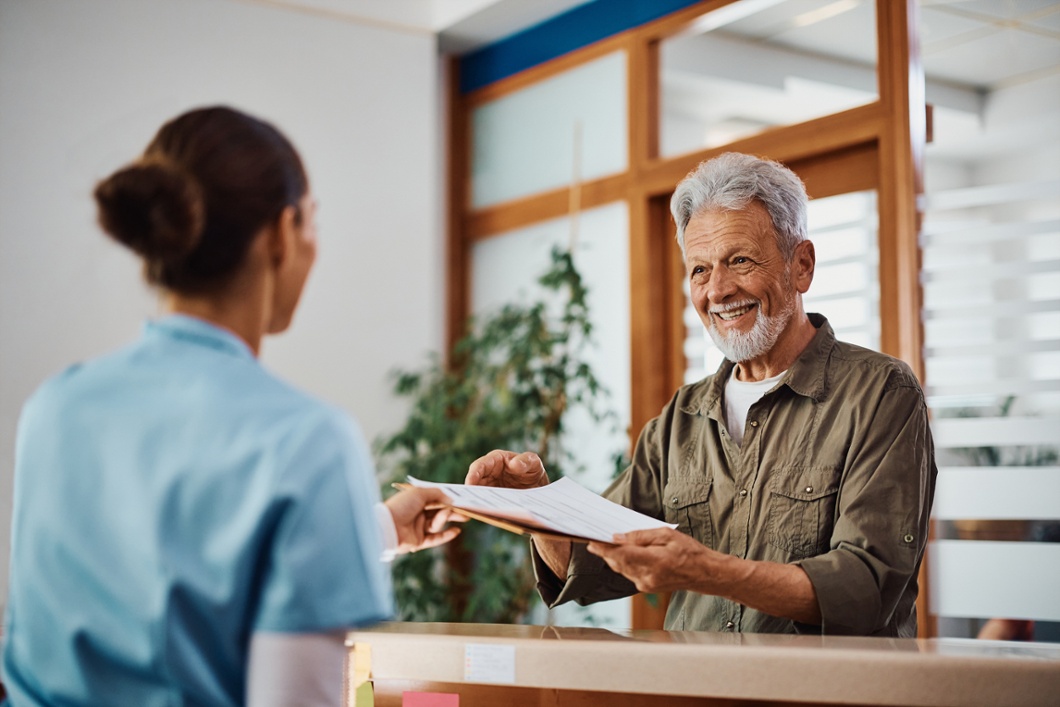 Nurse handing papers to a patient