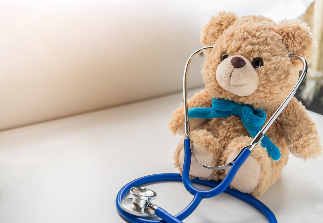 A teddy bear wearing a stethoscope